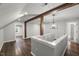 Finished attic with hardwood floors, wooden pillars, and chandelier at 2617 Fayetteville St, Durham, NC 27707