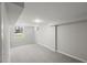 Basement area with plush carpeting and a window that brings in natural light at 2617 Fayetteville St, Durham, NC 27707