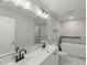 Bathroom featuring double vanity, bathtub, modern fixtures, and tiled floor at 2617 Fayetteville St, Durham, NC 27707
