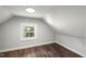 Cozy bedroom featuring a wood-look floor and a window letting in natural light at 2617 Fayetteville St, Durham, NC 27707