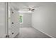 Bright bedroom with plush carpet, ceiling fan, and a bright window view at 2617 Fayetteville St, Durham, NC 27707