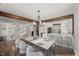 Staged dining room with open concept living and recently updated kitchen with bar stool seating at 2617 Fayetteville St, Durham, NC 27707