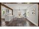 Staged dining area with hardwood floors, a modern chandelier, and a view into the renovated kitchen at 2617 Fayetteville St, Durham, NC 27707