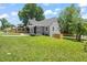 Charming gray home with well-maintained lawn, wooden fence, and inviting front porch at 2617 Fayetteville St, Durham, NC 27707