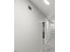 Hallway with closet, leading to a bedroom with carpeting and a light-filled window at 2617 Fayetteville St, Durham, NC 27707