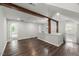 Open living area with dark wood floors, exposed beams, and ample natural light at 2617 Fayetteville St, Durham, NC 27707