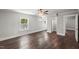 Open main bedroom featuring hardwood floors, two windows, and entry to the ensuite bathroom and walk-in closet at 2617 Fayetteville St, Durham, NC 27707