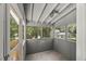 Bright screened-in sunroom with ample natural light and a view of the neighborhood at 2617 Fayetteville St, Durham, NC 27707