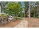 Large backyard featuring a rock garden, patio, and well-manicured landscaping at 3034 Lewis Farm Rd, Raleigh, NC 27607