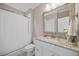 Bathroom with a shower and tub combo featuring a granite countertop and ample natural light at 3034 Lewis Farm Rd, Raleigh, NC 27607