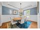 Cozy dining room featuring a wooden table, six chairs, blue walls, and an elegant chandelier at 3034 Lewis Farm Rd, Raleigh, NC 27607