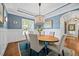 Light-filled dining room with an oval table, seating for six, and a view to the adjacent room at 3034 Lewis Farm Rd, Raleigh, NC 27607