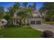 Charming home boasts a well-manicured lawn, flowering tree, and convenient two-car garage at 3034 Lewis Farm Rd, Raleigh, NC 27607