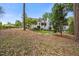 Beautiful home exterior with manicured lawn, mature trees, and outdoor entertaining spaces at 3034 Lewis Farm Rd, Raleigh, NC 27607