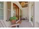 Charming front porch features wood chairs, potted plants, and wood shutters at 3034 Lewis Farm Rd, Raleigh, NC 27607