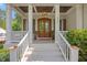Inviting porch with a wood ceiling, brick flooring, and white columns at 3034 Lewis Farm Rd, Raleigh, NC 27607