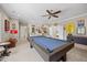 Entertaining game room with pool table, carpet flooring, and whimsical wall decor at 3034 Lewis Farm Rd, Raleigh, NC 27607