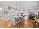 Open kitchen featuring a large center island with seating and granite countertops at 3034 Lewis Farm Rd, Raleigh, NC 27607