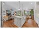 Spacious kitchen island with granite countertops, pendant lighting, stainless steel appliances, and hardwood floors at 3034 Lewis Farm Rd, Raleigh, NC 27607
