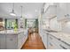 Bright kitchen with white cabinets, granite counters, stainless appliances, and views to the dining area at 3034 Lewis Farm Rd, Raleigh, NC 27607