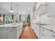 Open kitchen with granite counters, white cabinets, hardwood floors, and stainless steel appliances at 3034 Lewis Farm Rd, Raleigh, NC 27607