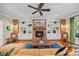 Inviting living room featuring a brick fireplace, built-in shelves, and plush seating at 3034 Lewis Farm Rd, Raleigh, NC 27607