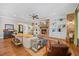 Spacious living room featuring a brick fireplace, built-in shelves, and hardwood floors at 3034 Lewis Farm Rd, Raleigh, NC 27607