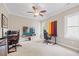 Office space that features a TV, a fan, and a gaming chair that provides plenty of natural light at 3034 Lewis Farm Rd, Raleigh, NC 27607