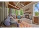Inviting outdoor patio with a cozy fireplace, comfortable seating, and a view of the surrounding greenery at 3034 Lewis Farm Rd, Raleigh, NC 27607