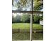 View of backyard with a lush lawn and partial fence at 313 W Noble St, Louisburg, NC 27549