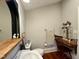 Bright bathroom with a pedestal sink, framed mirror, wood floors, vanity, and a serene ambiance at 313 W Noble St, Louisburg, NC 27549