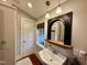 Classic bathroom features a pedestal sink, framed mirror, natural light, and neutral tones at 313 W Noble St, Louisburg, NC 27549
