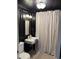Modern bathroom with sleek black walls, pedestal sink, and stylish fixtures at 313 W Noble St, Louisburg, NC 27549