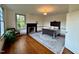 Bedroom featuring hardwood floors, a decorative fireplace, and bright, natural light at 313 W Noble St, Louisburg, NC 27549