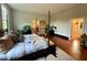 Spacious bedroom features plants and natural light from window, enhancing its cozy ambiance at 313 W Noble St, Louisburg, NC 27549