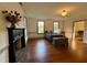 Bedroom featuring hardwood floors, a decorative fireplace, and two windows at 313 W Noble St, Louisburg, NC 27549