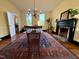 Bright dining room featuring a fireplace, hardwood floors, large windows, and space for entertaining at 313 W Noble St, Louisburg, NC 27549