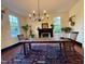 Inviting dining room with a rustic wooden table, area rug, fireplace, and mounted deer head at 313 W Noble St, Louisburg, NC 27549