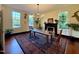 Bright dining room with natural light, rustic table, black fireplace, and classic wooden chairs at 313 W Noble St, Louisburg, NC 27549