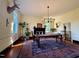 Bright dining room with a rustic wooden table, area rug, black fireplace, and classic wooden chairs at 313 W Noble St, Louisburg, NC 27549