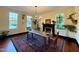 Sun-filled dining room featuring a wooden table, area rug, black fireplace, and abundant natural light at 313 W Noble St, Louisburg, NC 27549
