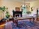 Charming dining room with a rustic wooden table, area rug, black fireplace, and a unique chandelier at 313 W Noble St, Louisburg, NC 27549