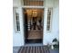 Inviting foyer with black and white checkered floors, a staircase, and an elegant chandelier at 313 W Noble St, Louisburg, NC 27549