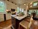 Eat-in kitchen featuring white cabinets, granite counters, stainless steel appliances, and breakfast bar seating at 313 W Noble St, Louisburg, NC 27549