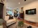 Inviting living room with hardwood floors, a comfortable armchair, and a view into the dining area at 313 W Noble St, Louisburg, NC 27549