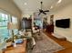 Cozy living room boasts natural light, hardwood floors, and views into the kitchen at 313 W Noble St, Louisburg, NC 27549