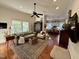 Bright living room featuring hardwood floors, comfortable seating, and an open layout with the kitchen at 313 W Noble St, Louisburg, NC 27549