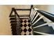 Top-down view of a staircase with a unique black and white patterned landing at 313 W Noble St, Louisburg, NC 27549