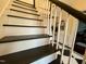Elegant staircase with black and white accents, leading to the upper level at 313 W Noble St, Louisburg, NC 27549