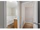 Bright bathroom with a soaking tub, vanity, and an open doorway to a closet at 330 Gilman Ln # 109, Raleigh, NC 27610